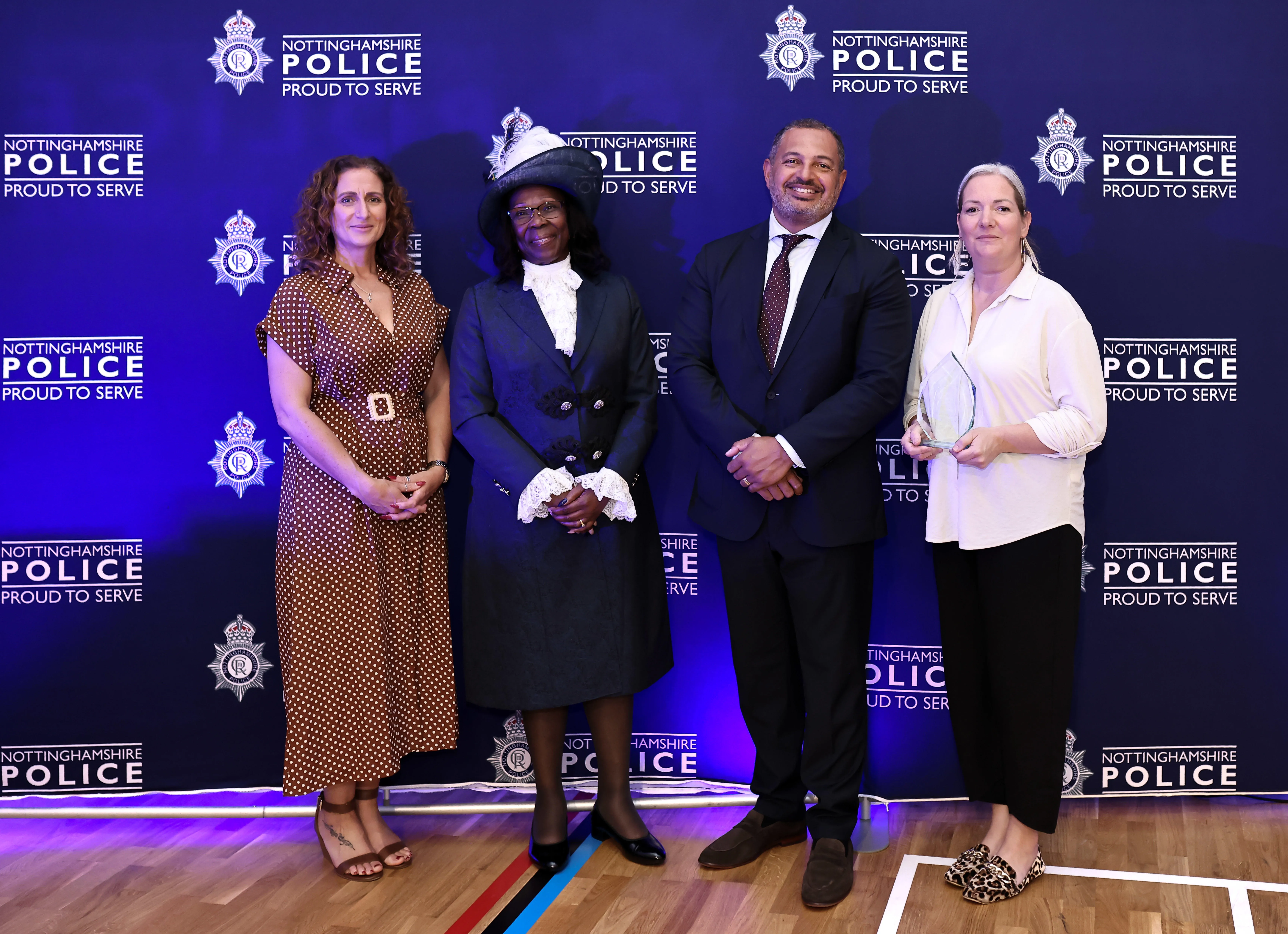PCC Gary Godden presenting the Vulnerability Award to representatives from Deaf-initely Women.