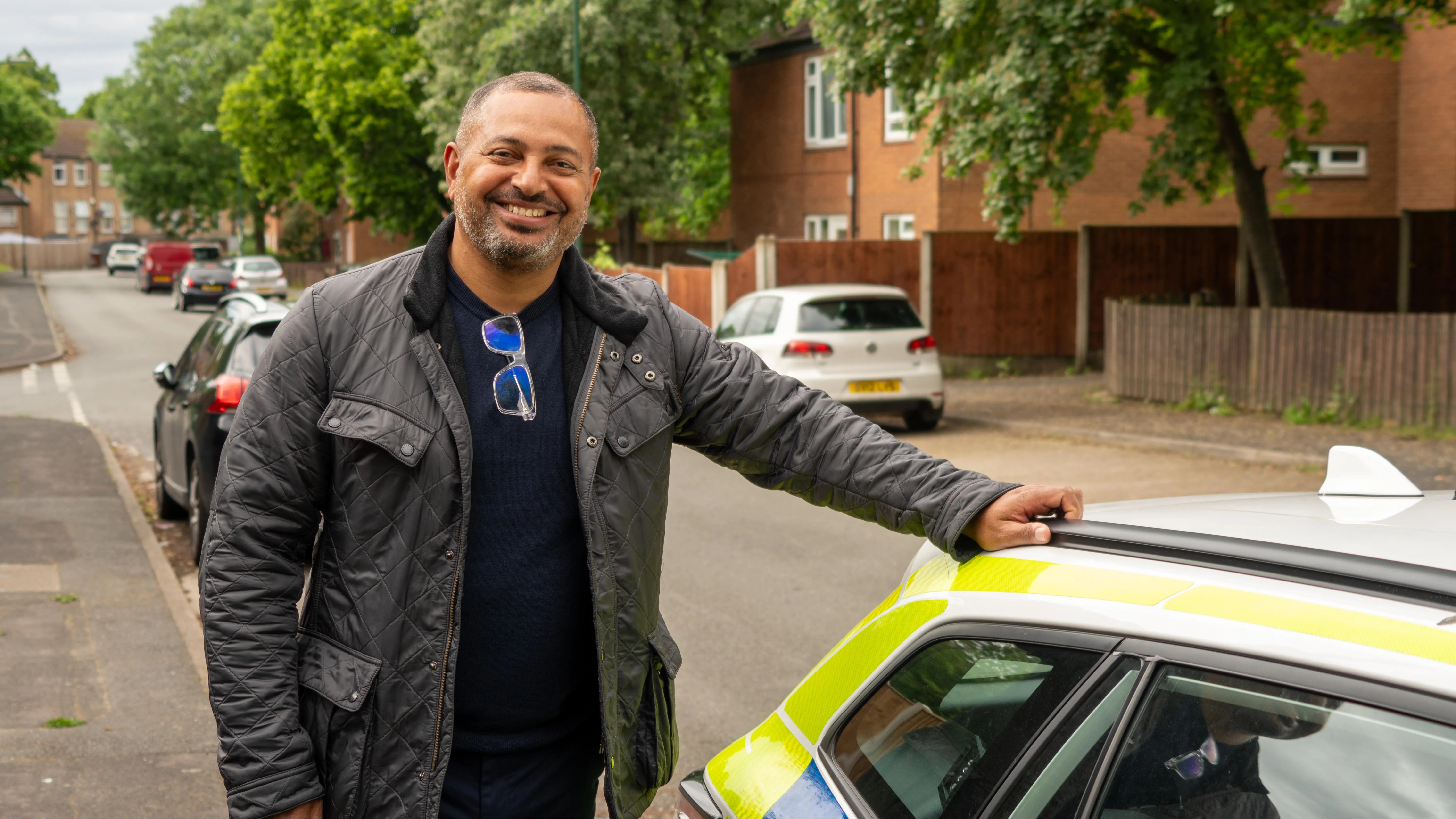Nottinghamshire PCC Gary Godden leaning against a police car