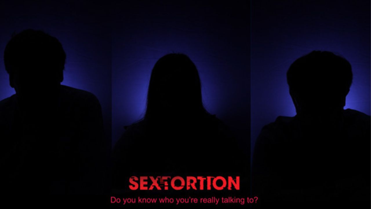 A darkened image with the word sextortion in red