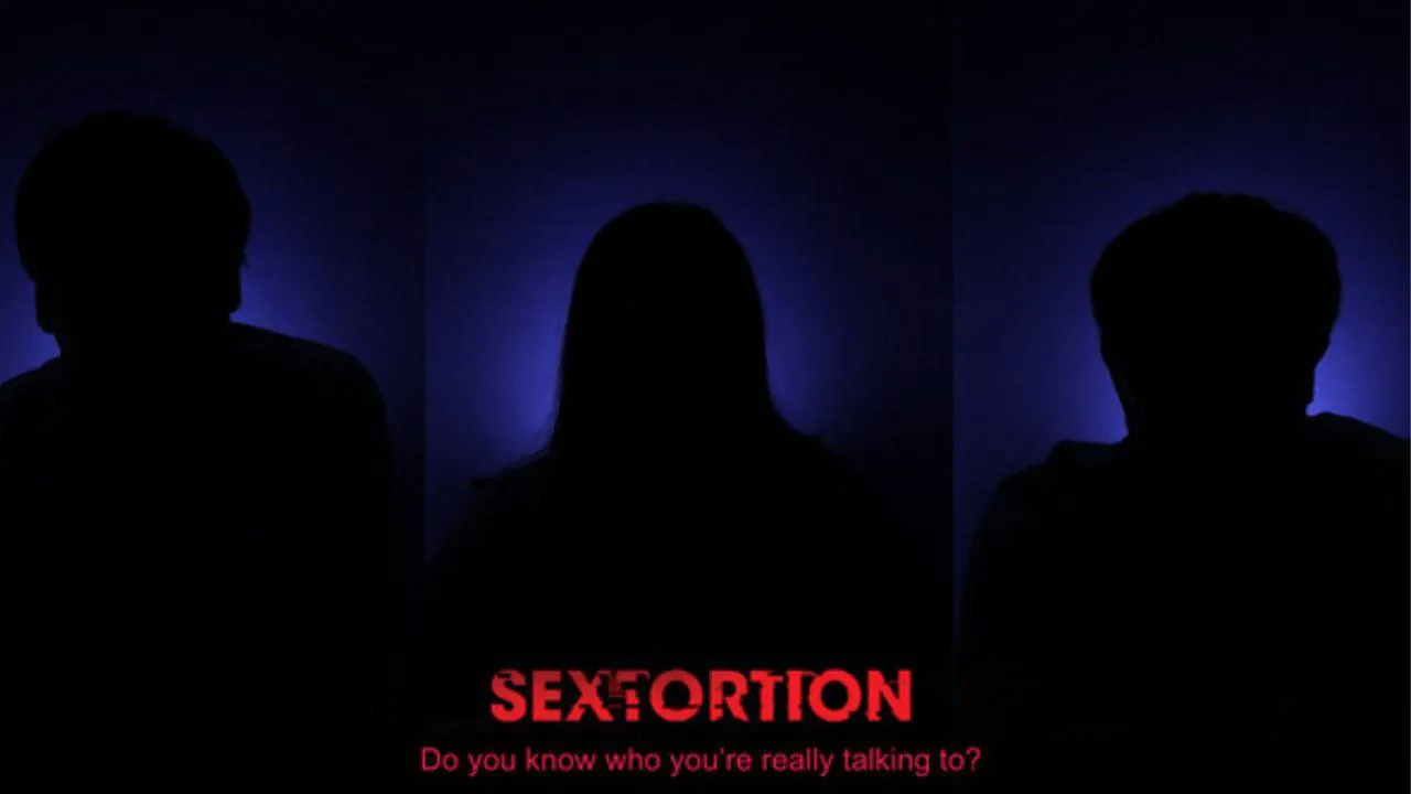 A darkened image with the word sextortion in red