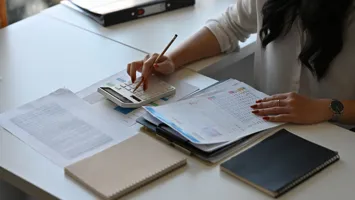 someone completing accounts documents