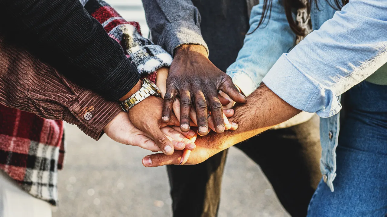 people putting their hands on top of each other