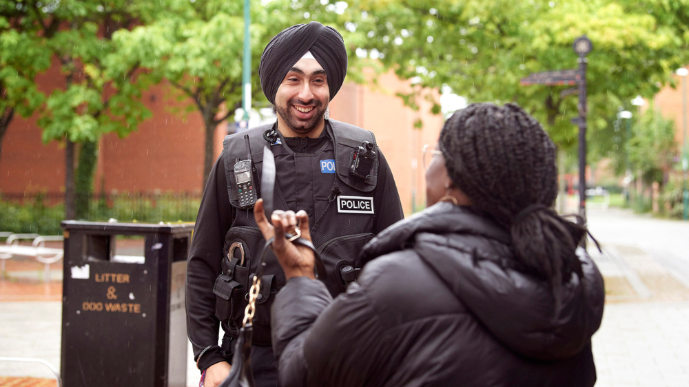 The IAG aims to improve community involvement. Picture of a police officer engaging with a member of the public.