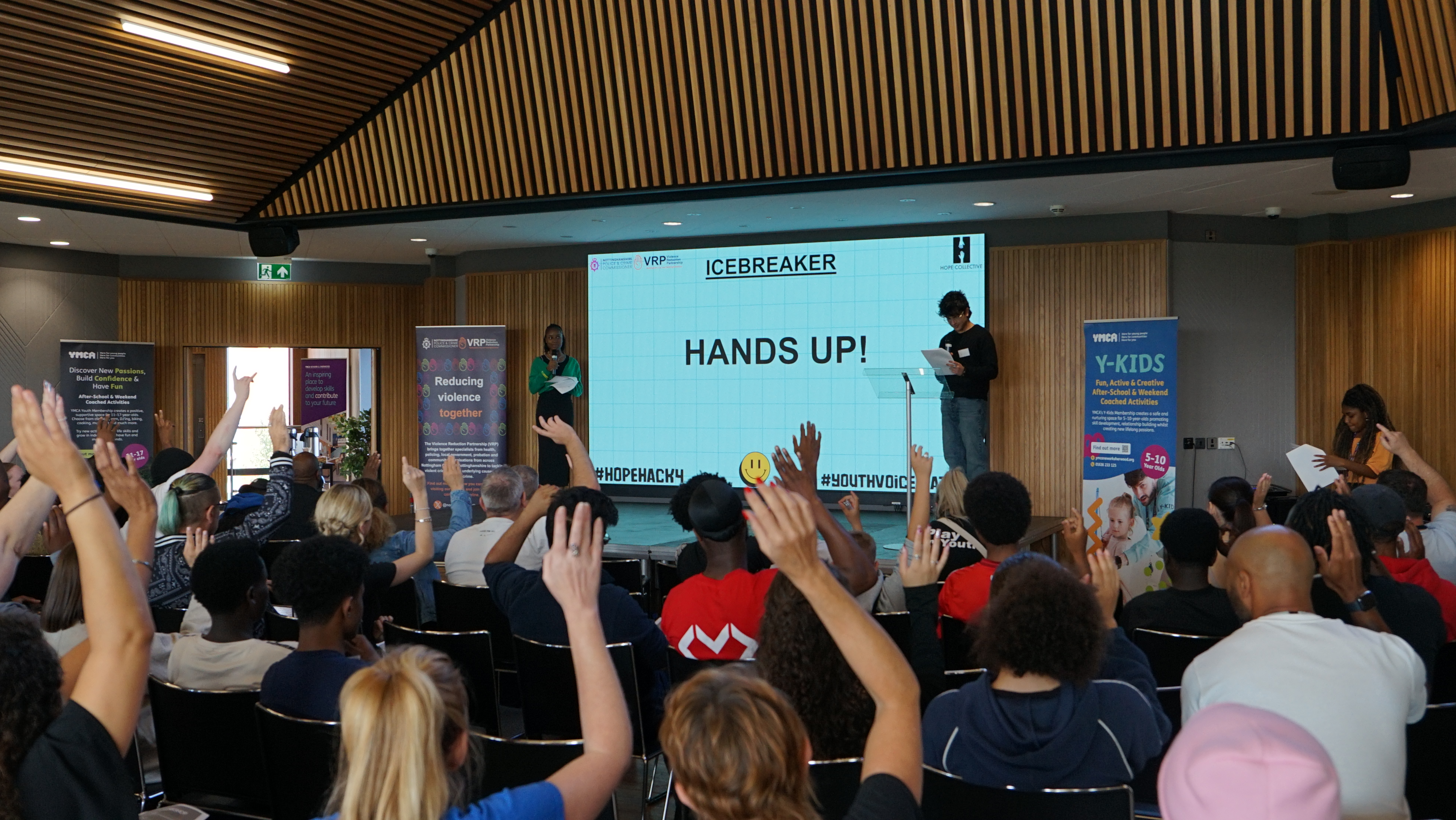 Young people raise their hands to give their views