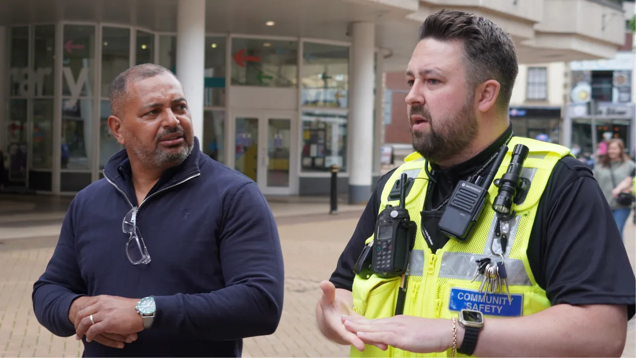 PCC Gary Godden out in the community talking to a community safety officer.